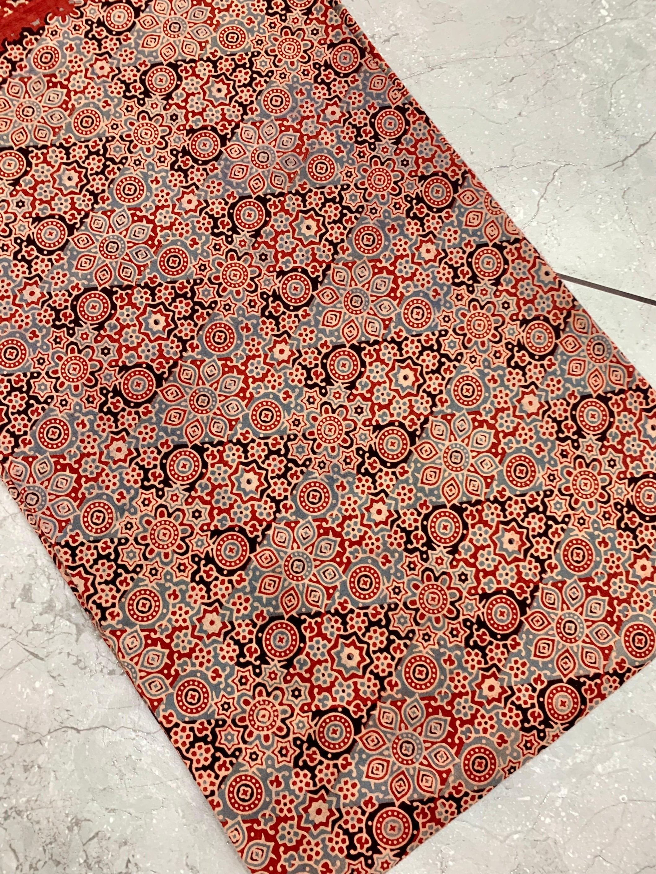 Maroon floral Ajrakh printed pure cotton wholesale fabric with artisan-crafted organic dye motifs.